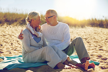 Image showing happy senior couple hugging on summer beach