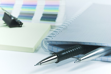 Image showing Pens and blank notebook