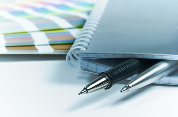 Image showing blank notrbook, pens, color guide