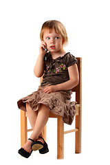 Image showing Pretty girl in big shoes talking by phone.