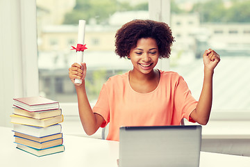 Image showing happy african woman with laptop, books and diploma