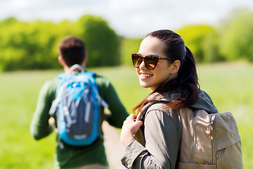 Image showing happy couple with backpacks hiking outdoors