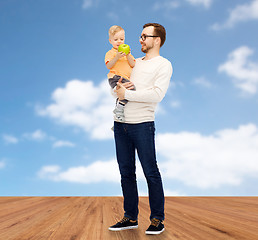 Image showing happy father and little son with green apple