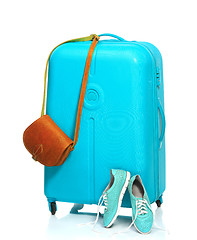 Image showing The blue suitcase, sneakers, handbag on white background.