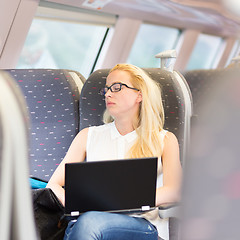 Image showing Woman naping while travelling by train.