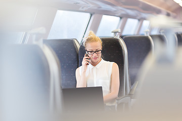 Image showing Business woman working while travelling by train.