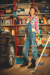 Image showing Full length portrait of a smiling female mechanic