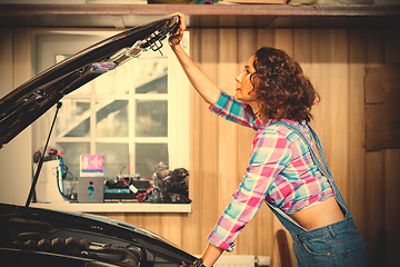 Image showing beautiful woman mechanic in a garage