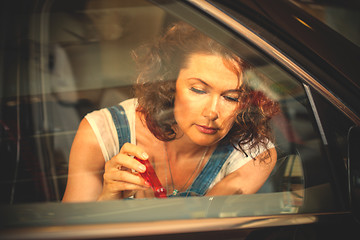 Image showing emale mechanic repairing a car door with a screwdriver