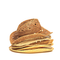 Image showing The lot of straw hats isolated on white background.