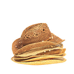 Image showing The lot of straw hats isolated on white background.