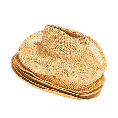 Image showing The lot of straw hats isolated on white background.