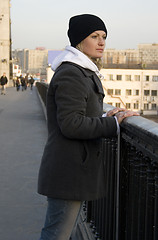 Image showing The thoughtful pretty womanl on the bridge