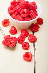 Image showing bunch of fresh raspberry on a bowl and white table