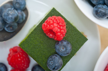 Image showing green tea matcha mousse cake with berries