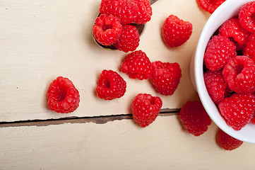 Image showing bunch of fresh raspberry on a bowl and white table