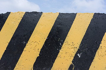 Image showing Yellow and black concrete barrier