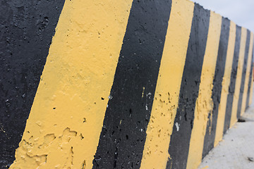 Image showing Yellow and black concrete barrier