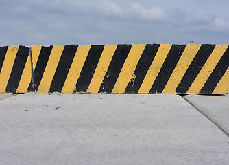 Image showing Yellow and black concrete barrier