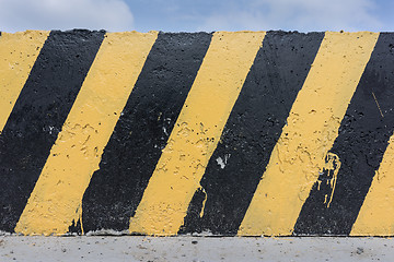 Image showing Yellow and black concrete barrier