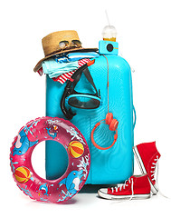 Image showing The blue suitcase, sneakers, hat and rubber ring on white background.