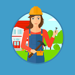 Image showing Cheerful builder with hammer.