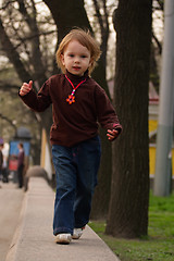 Image showing Little girl running to photographer or audience.