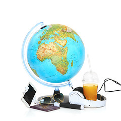 Image showing The blue globe, phone, sunglasses and headphones on white background.