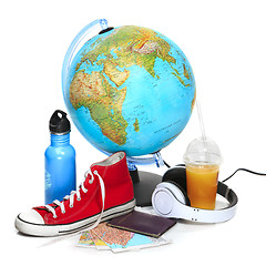 Image showing The blue globe, sneakers, thermos and headphones on white background.