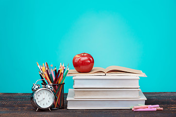 Image showing Back to School concept. Books, colored pencils and clock