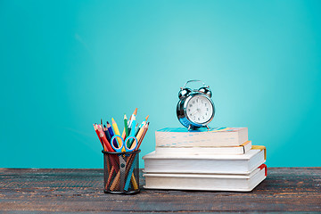 Image showing Back to School concept. Books, colored pencils and clock