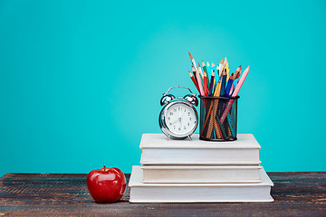 Image showing Back to School concept. Books, colored pencils and clock