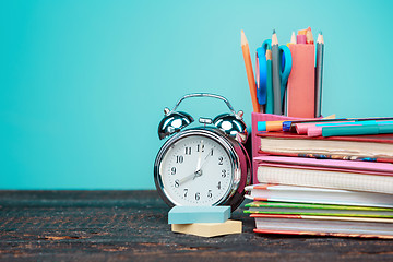 Image showing Back to School concept. Books, colored pencils and clock