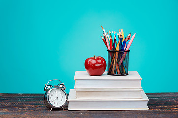 Image showing Back to School concept. Books, colored pencils and clock