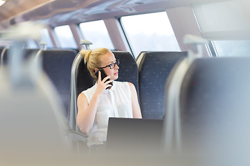 Image showing Business woman working while travelling by train.