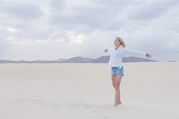 Image showing Carefree woman enjoying freedom on beach.