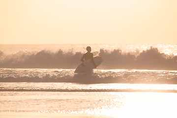 Image showing Surfers on beach with surfboard.