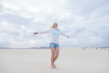 Image showing Carefree woman enjoying freedom on beach.