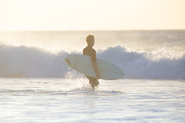 Image showing Surfers on beach with surfboard.
