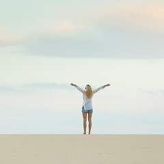 Image showing Free woman enjoying freedom on beach at dusk.