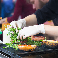 Image showing Beef burgers ready to serve on food stall.