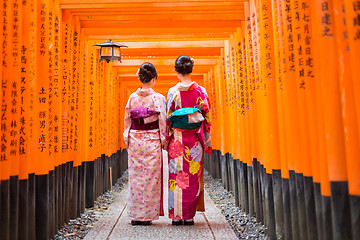 Image showing Geishas among red wooden Tori Gate at Fushimi Inari Shrine in Kyoto, Japan
