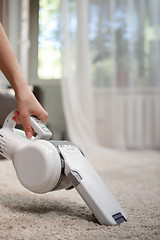 Image showing Woman cleaning carpet cordless handheld vacuum cleaner