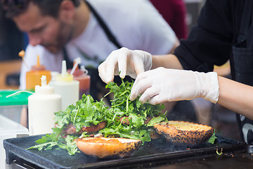 Image showing Beef burgers ready to serve on food stall.