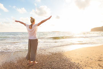 Image showing Free Happy Woman Enjoying Sunset on Sandy Beach