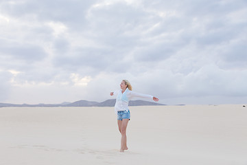 Image showing Carefree woman enjoying freedom on beach.