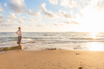 Image showing Free Happy Woman Enjoying Sunset on Sandy Beach