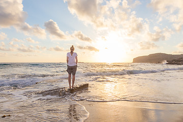 Image showing Free Happy Woman Enjoying Sunset on Sandy Beach