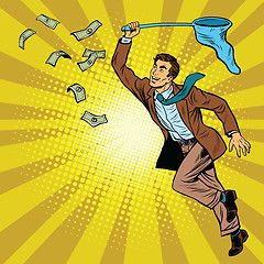 Image showing Business man catching money with a butterfly net