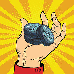 Image showing Hand with car tires